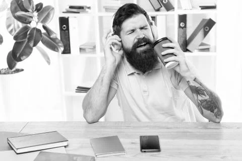 Regular office day. Man bearded guy headphones sit office listen music sing song Stock Photos