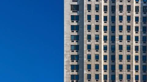 Regular pattern made of rectangular windows on block of flats / offices build Stock Photos