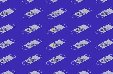 Regular Pattern Of Medical Face Masks With Flowers And Blue Background. Stock Photos
