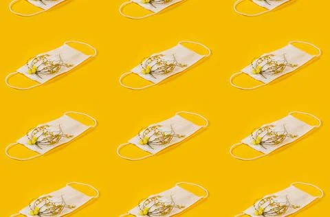 Regular Pattern Of Medical Face Masks With Yellow Flowers And Yellow Backgrou Stock Photos