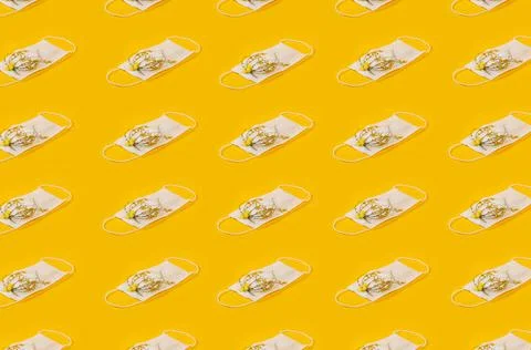 Regular Pattern Of Medical Face Masks With Yellow Flowers And Yellow Backgrou Stock Photos