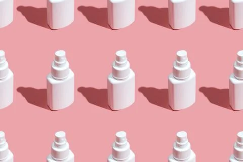 Regular Pattern of spray sanitizer tubes on the pink table flat lay. Fabric Stock Photos