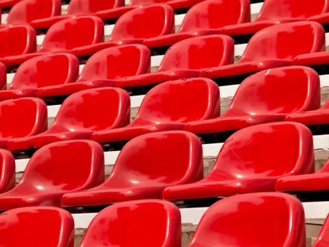 Regular red seats in a stadium Stock Photos