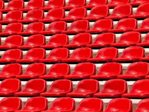Regular red seats in a stadium Stock Photos