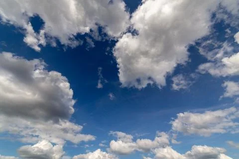 Regular spring clouds on blue sky at daylight in continental europe. Close shot Stock Photos