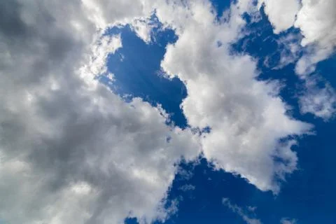 Regular spring clouds on blue sky at daylight in continental europe. Upward shot Stock Photos