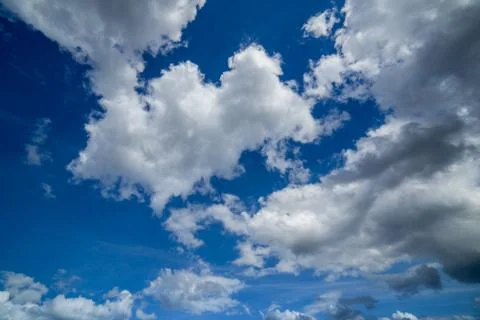 Regular spring clouds on blue sky at daylight in continental europe. Close shot Stock Photos