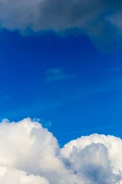 Regular spring clouds on blue sky at daylight in continental europe. Close shot 库存照片