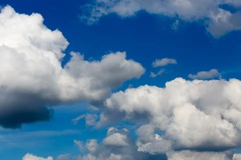 Regular spring clouds on blue sky at daylight in continental europe. Close shot Photos