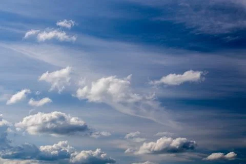 Regular spring clouds on blue sky at daylight in continental europe. Shot wit Stock Photos