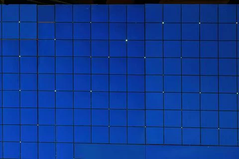 Regular wall full of blue squares close-up Stock Photos
