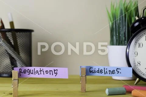 Regulations and Guidelines. Handwriting on sticky notes in clothes pegs Stock Photos