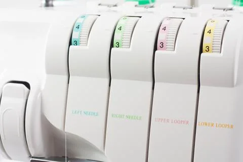 Regulators of a tension of threads on white overlock Stock Photos