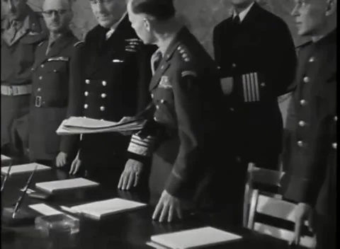 REIMS - 1945: German surrender signing - Officer leans over documents Stock Footage 343791253