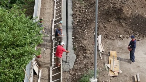 Reinforced concrete casting for the construction of a boundary wall Stock Footage 139974600
