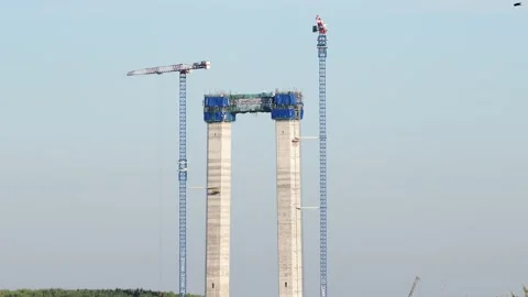 Reinforced concrete pillars under construction with crane for suspension bridge Stock Footage 147407557