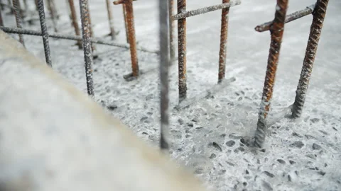 Reinforcement bars set in hardened concrete foundation Stock Footage 306335673