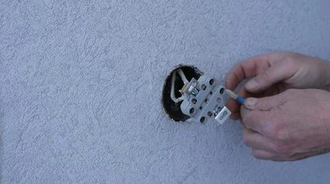 Reinstalling the wall socket by male hands Stock Photos