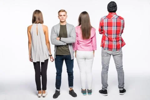 Reir view of a casual group of people with a man facing the camera isolated o Stock Photos
