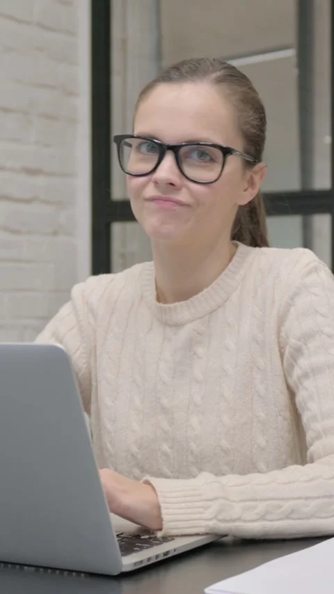Rejecting Creative Woman Looking at Camera while Using Laptop, vertical video Stock Footage 325831535