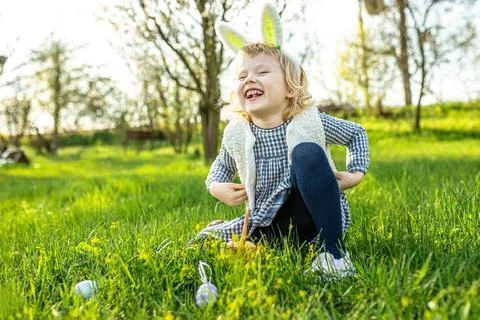 Rejoicing in the feast of Easter and waiting to search for Easter eggs in the Stock Photos