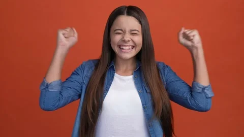 Rejoicing kid win luck contest fists up scream isolated brick color background Stock Footage 166900608