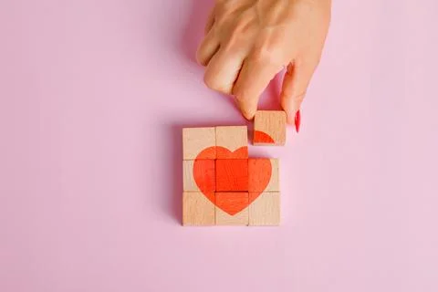 Relationship concept on pink background flat lay. finger pulling out wooden.. Stock Photos