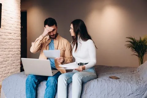 Relationship difficulties and obstacles. young couple with problems with bills Stock Photos