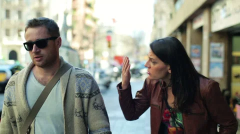 Relationship difficulties: arguing couple walking along the street Stockbeeldmateriaal 36637442