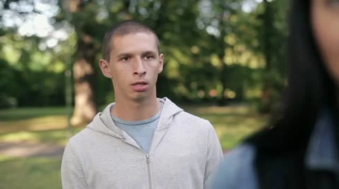 Relationship difficulties, couple fighting in the park, steadicam shot HD Video stock 12014782