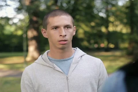 Relationship difficulties, couple fighting in the park, steadicam shot NTSC Stock Footage 12014787