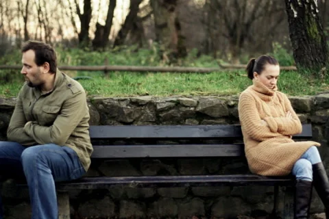 Relationship difficulties, young couple sitting on bench in the park Stock Footage 943742