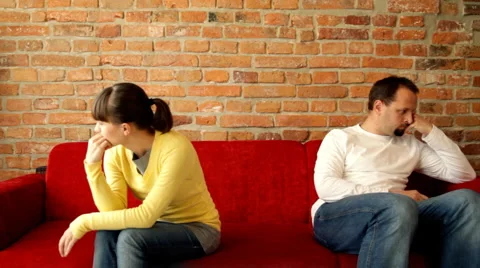 Relationship difficulties, young couple sitting on sofa apart Stock Footage 1214670