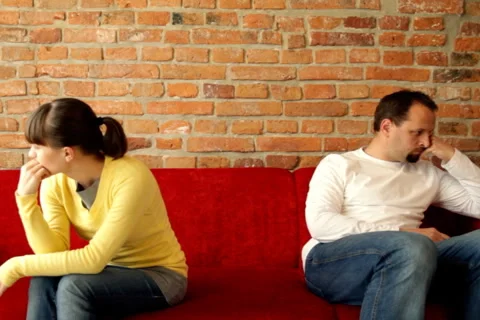 Relationship difficulties, young couple sitting on sofa apart Stock Footage 1214676