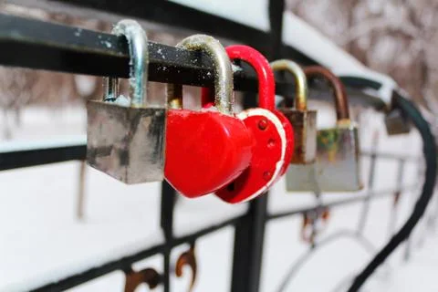 Relationship, lock in shape of heart on the bridge on a wedding tradition, wa Stock Photos