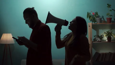 Relationship problems difficulties issues concept. Angry wife yells at her Stock Footage 254181443