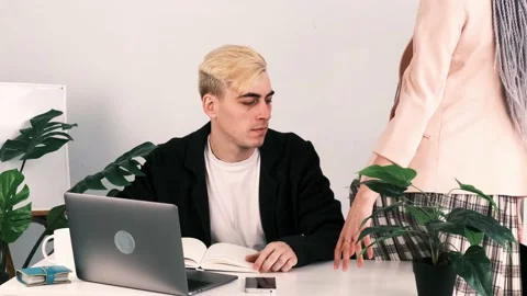 Relationships at work, office romance. Young attractive employee with gray 動画素材 230082931