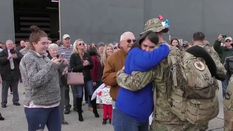 Relatives embrace airmen on return from deployment 스톡 동영상 97162815