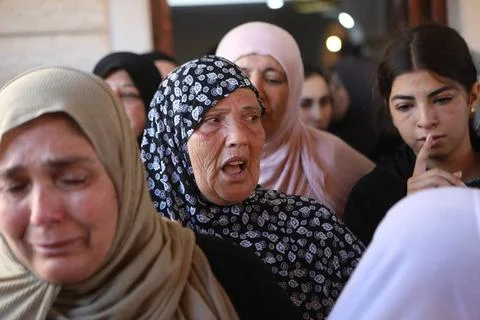  Relatives react during the funeral of an 18-year-old Palestinian who was ... Stock Photos