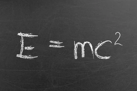 Relativity equation E mc2 handwritten by chalk on a university blackboard Stock Photos