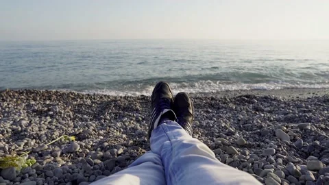 Relax on the beach with a view of the legs and the sea. Stock Footage 146027575