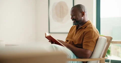 Relax, black man and reading book in house with funny story, smile and Stock Footage 337755982