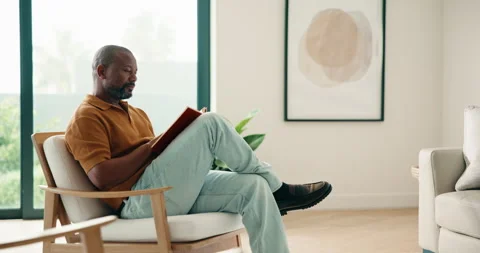 Relax, black man and reading book in home with peace, calm and literature on Stock Footage 337763282