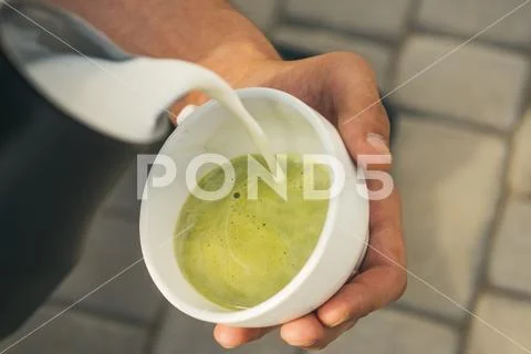 Relax in cafe or coffee shop and drinking. matcha latte tea ceremony, pour milk Stock Photos