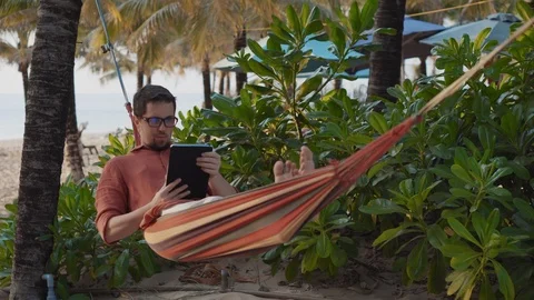 Relax in hammock with tablet Stock Footage 127567851