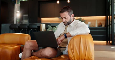 Relax, laptop and typing with man on sofa for streaming service, online review Stock Footage 303624878