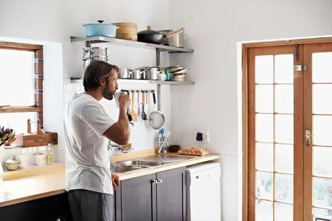 Relax, man and thinking with coffee in kitchen to start day, peaceful morning or Stock Photos