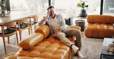 Relax, man or happy on sofa with phone call, friendly chat or weekend catch.. Stock Photos
