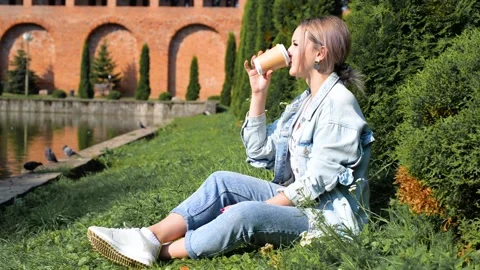 Relax, rest, enjoyment, coffee break. Beautiful young woman drinking latte Видео 164451792