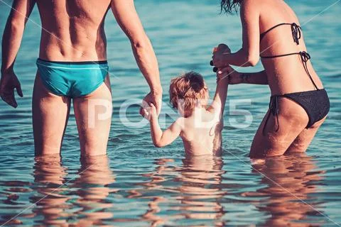 Relax in summer vacation. relax of young family with small boy in sea water. Stock Photos